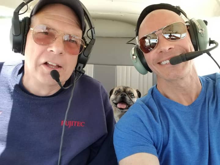 Paramus Police Det. Sgt. Glenn Pagano and copilot/rescue official Andy Davie fly Rocco from Ohio to New York to meet his new family.