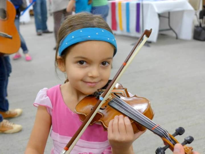 A young Thurnauer Music School musician and her violin. Celebrate Chanukah in Tenafly with music Dec. 6.