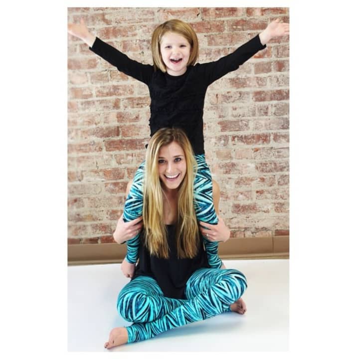 Nicole Lidestri with another young cheerleader pose for a photo for XX.