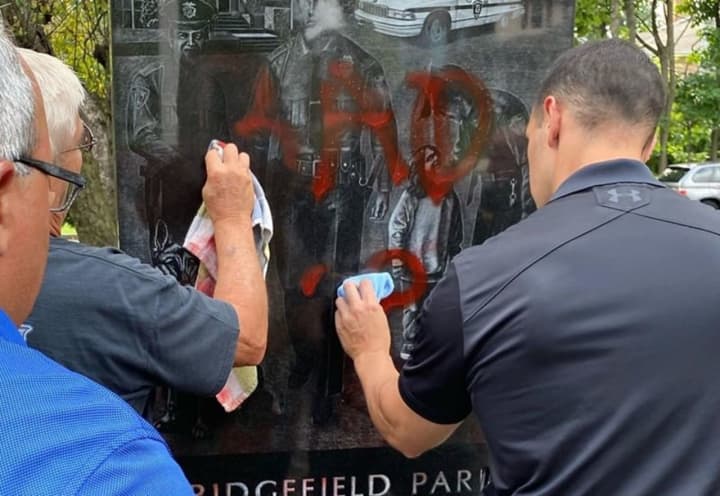 Ridgefield Park&#x27;s finest clean the graffiti from the memorial.