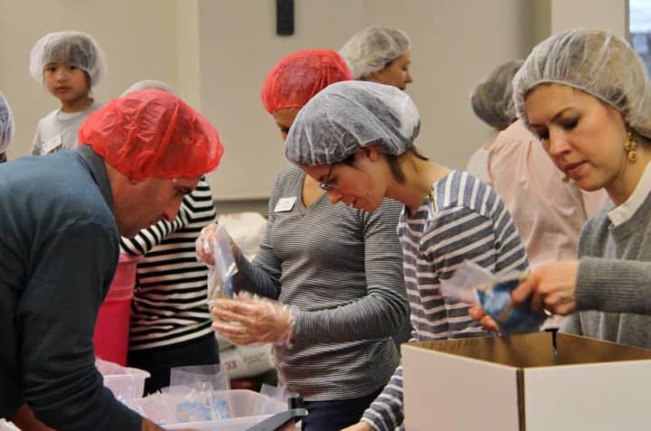 Volunteers pack food at the 2015 Hunger Project event.