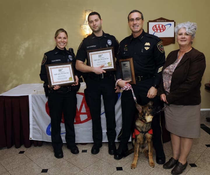 AAA Public Affairs Manager Fran Mayko, right, presents, from left, Redding Police officers Michael Livingston and Jenna Matthews and Redding Police Chief Doug Fuchs with their awards. Kato, a service dog in training, is also shown.