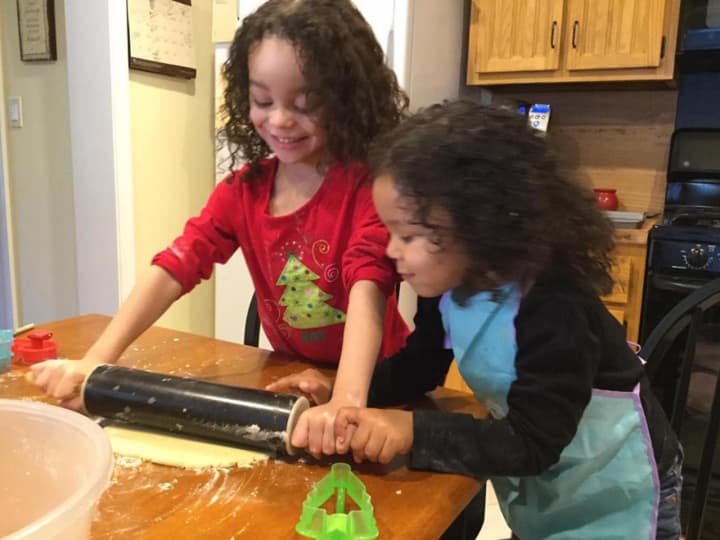 Layla and Ari roll out the cookie dough.