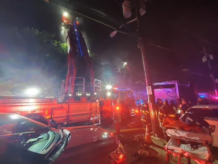 The overnight fire tore through one multi-family building at 77 Mill Street in Paterson and damaged several others.