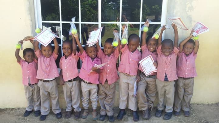 Children in Jamaica celebrate a gift given by the RKM Foundation. A Wyckoff gym will hold a fundraiser for the organization Jan. 30.