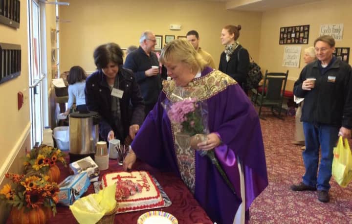 The Rev. Kathryn King cuts her cake to celebrate her 20th anniversary of her ordination at St. Alban&#x27;s Episcopal Church in Oakland.
