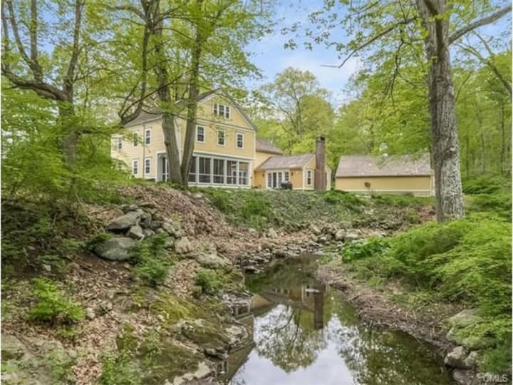 122 Ridgefield Road offers over 8 acres of land which includes a brook and meadow.