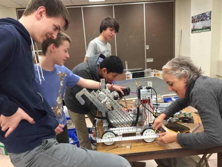 Mamaroneck High School Principal Elizabeth Clain helps the teens with their robot.