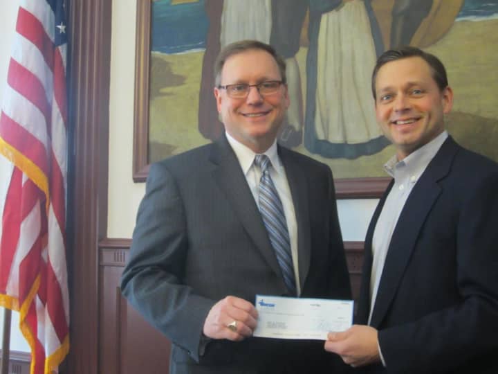 ENCON CEO Bill Valus presents a check for $1,600 to the Town of Stratford’s open space fund.