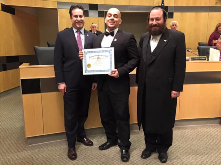Rockland County Legislators Alden H. Wolfe, left, and Aron B. Wieder, right, present the Board&#x27;s Distinguished Service Award to Joey Resto, center.