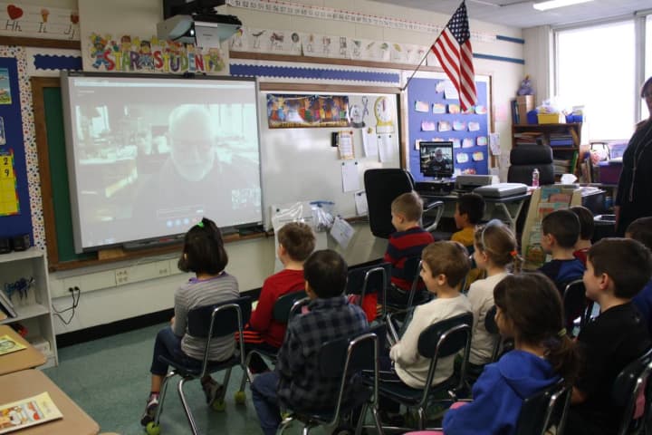 Tomie DePaola appeared on the smartboard screen as the children eagerly raised their hands for a chance to ask him questions.