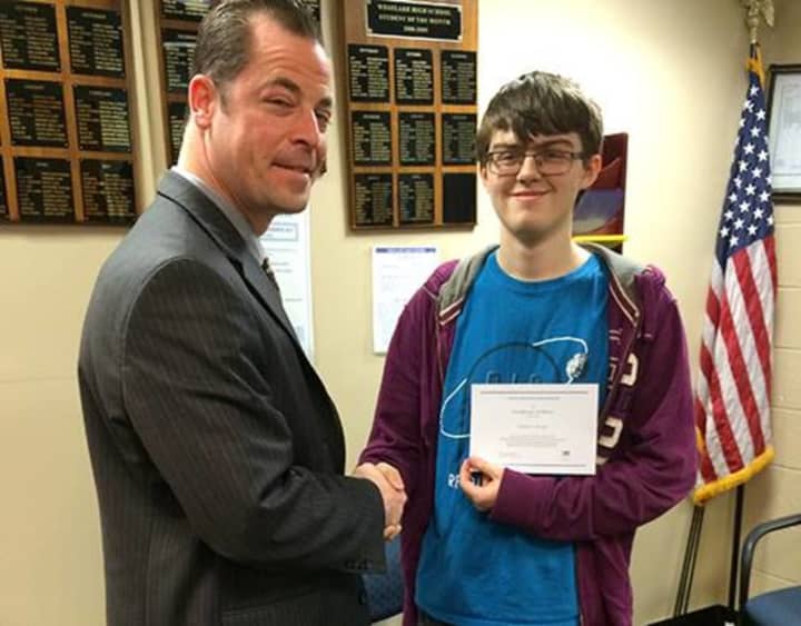 Westlake High School Principal Keith Schenker congratulates Will Sweeny on being named a finalist for the National Merit Scholarship Program.