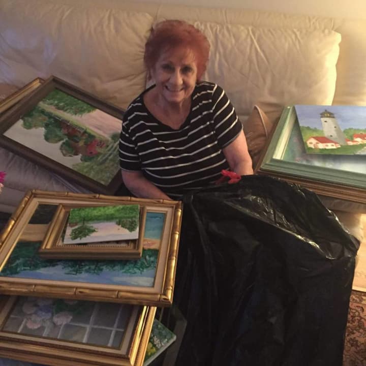 Ann Tomkins, of Moonachie, surrounded by some of her paintings.