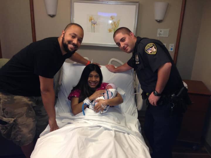 Eastchester police officer and EMS chief Nick Louros, visits with the mother and baby he helped deliver in a taxi earlier this week.