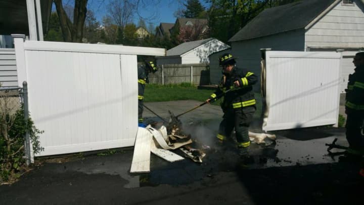 The Greenwich Fire Department tackles a fence blaze on Thursday.
