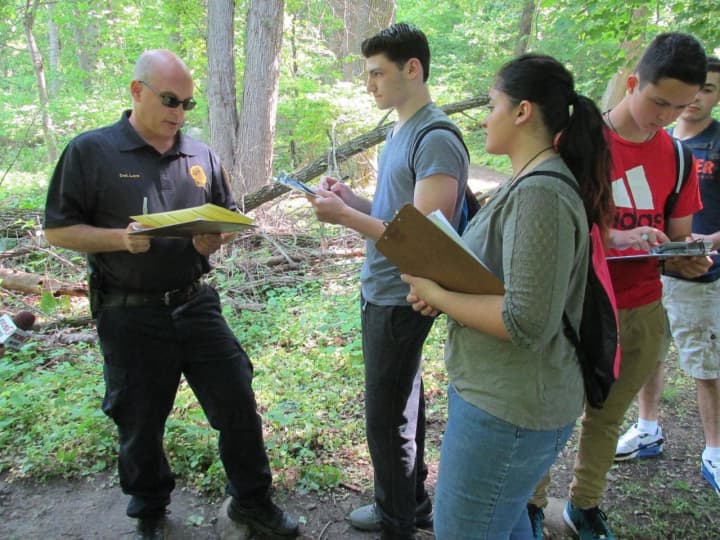 New Rochelle police officers assisted students in Scott Rubins&#x27; forensics class.