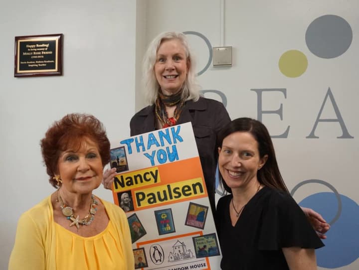 Nancy Paulsen, center, president and publisher of Nancy Paulsen Books, recently donated a 1,000 books to the Davis Library Media Center in New Rochelle.