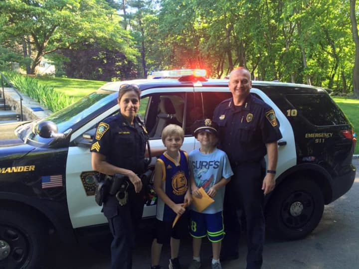 Two Fox Run Elementary School students won a ride to school with the Norwalk Police Chief.