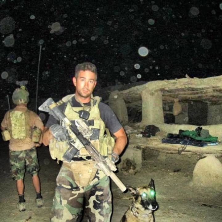Officer Eric Patenaude and K-9 Harco prior to a night mission during their deployment to Afghanistan in 2012 with the Marines.