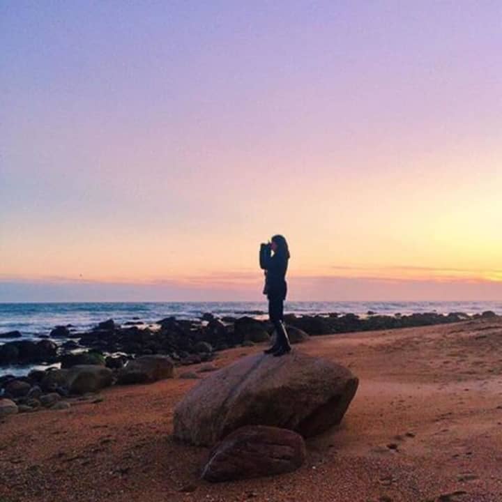 Lindsay Toia photographing the sunset in Westerly, R.I.