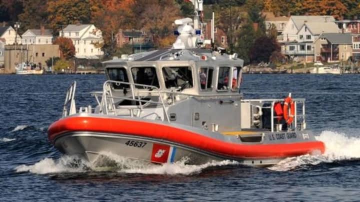 Coast Guard members helped rescue four people after their boat capsized.
