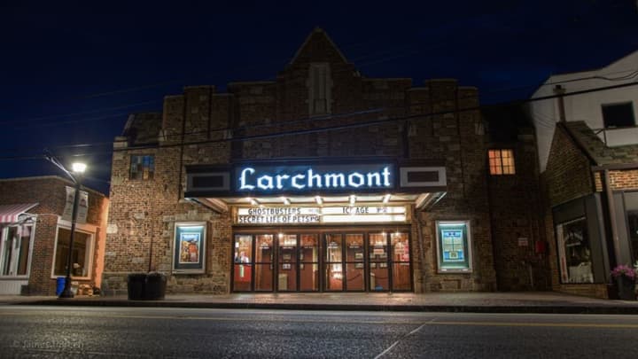 The Larchmont Playhouse lit up at night before it closed.