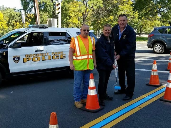 Rochelle Park Police Chief Robert Flannelly and Police Commissioner Jay Kovalcik joined DPW laborer Roy Spraguer in paint the township&#x27;s thin blue line.