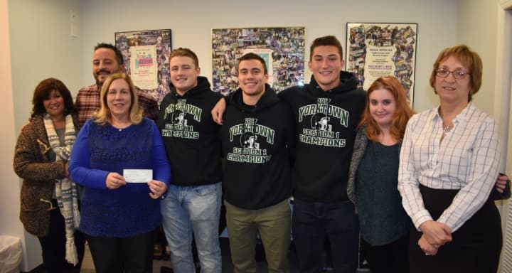 Members of Yorktown High School football team present their donation to Support Connection