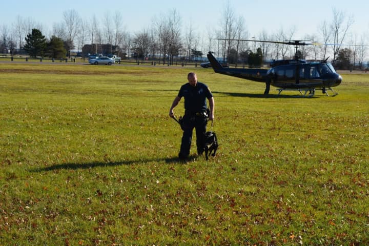 A Norwalk police officer and K9 train at Sherwood Island State Park.