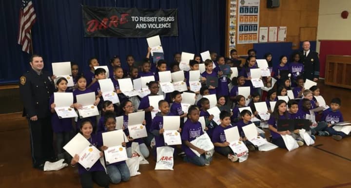 Fifth-grade students from Hempstead Elementary School show off their DARE certificates.