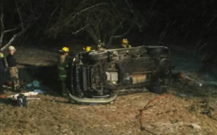 Firefighters respond Saturday evening to a rollover crash on East Village Road.