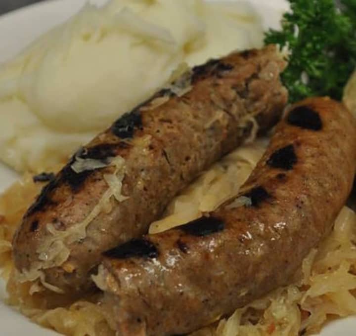 A kielbasa with kapusta dinner with mashed potatoes.