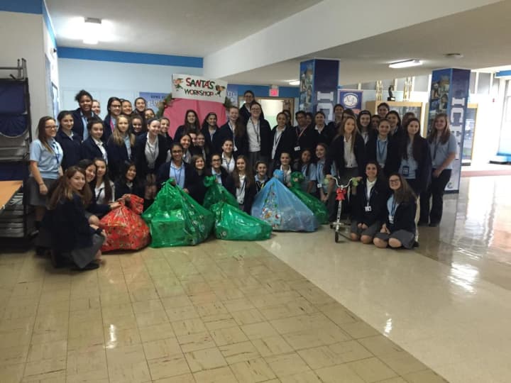 Students assembled at Immaculate Conception High School had a party to wrap the donated toys.