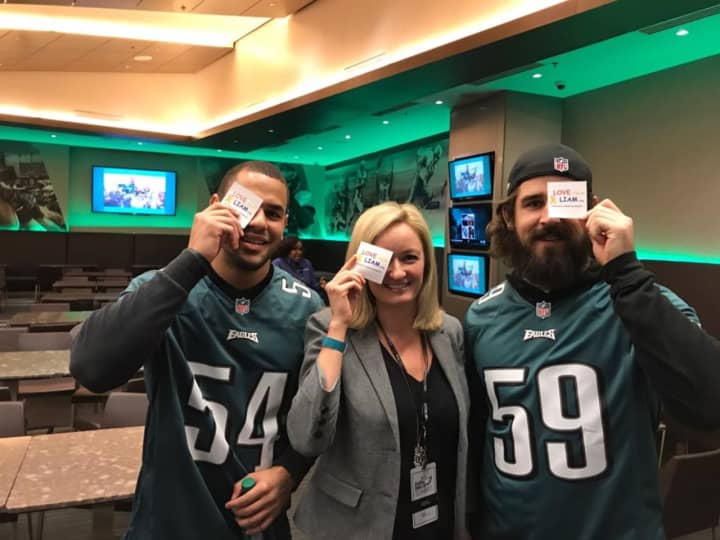 Jessica Spingler of Oakland sports a LoveFromLiam eye patch with Philadelphia Eagles players Kamu Grugier-Hill, left, and Joe Walker.