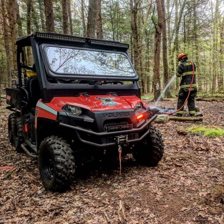 The Polaris is put to use by a firefighter from the Long Hill Volunteer Fire Department to put out an unattended campfire on Sunday in Trumbull.