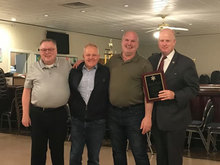 Sgt DiStasio with members of the police department, both active and retired, as well as receiving a commemorative plaque and kind words from Sheriff Gannon,  County Commissioner Douglas Cabana and Mt Arlington Borough Council President Jack Delaney