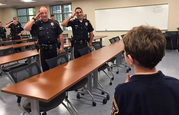 Sheriff&#x27;s officers salute their &quot;Chief for a Day.&quot;