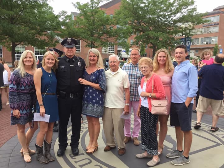 New Brookfield Police Officer Tommy Robbins is surrounded by his friends and family after graduating Monday from the State Of Connecticut Police Academy.