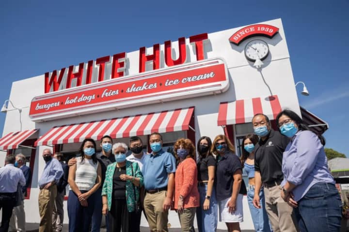 The Yee family and friends on Thursday honoring their lost loved one in front of the White Hut restaurant.