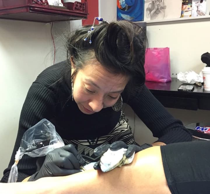 Amanda Allen, aka Ace, tattoos a customer at Seppuku in Bloomingdale.