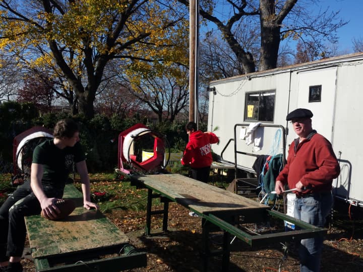 Ridgefield Park-Bogota Rotary and local Boy Scouts prepare trees at an annual Christmas tree sale. 