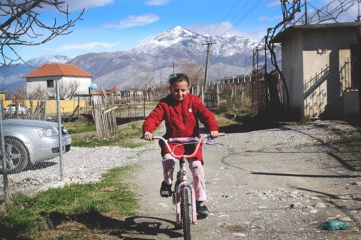 An Albanian girl rides her Pedals for Progress bike.