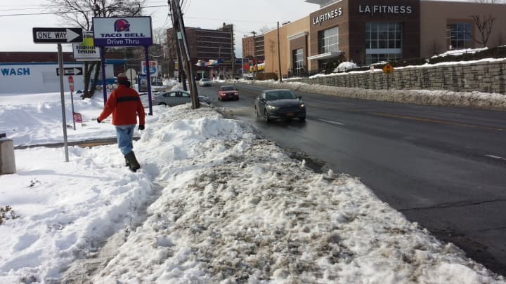 It was rough going on Monday for pedestrians along Route 1 in Port Chester, where some stretches of sidewalk were shoveled but others were not. This walker trudges through snow near Pearl Street. A stretch near Kohl&#x27;s Shopping Center also was bad.