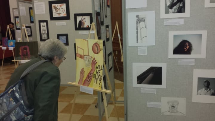 A visitor enjoys some of the more than 100 pieces of art on display Monday during Port Chester High School&#x27;s second annual IB Visual Arts show.