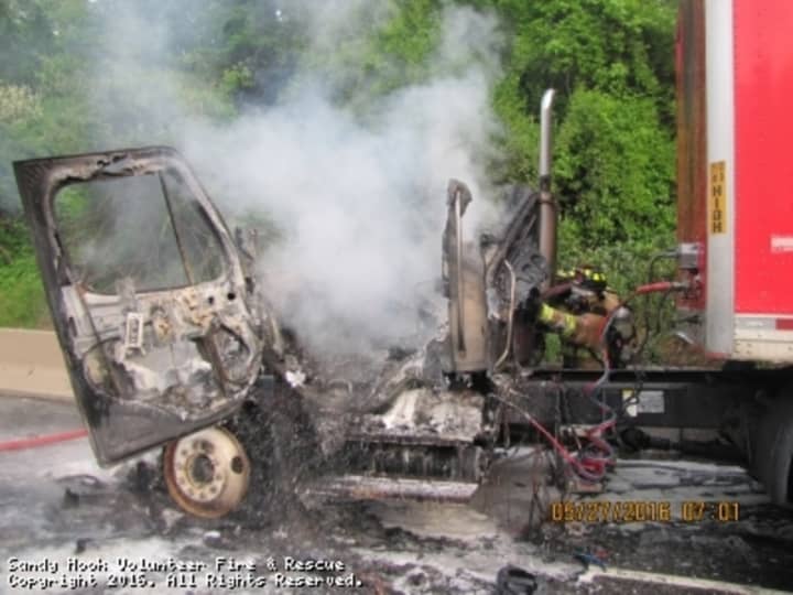 The cab of the tractor-trailer was completely destroyed in the fire, but the driver escaped unharmed.