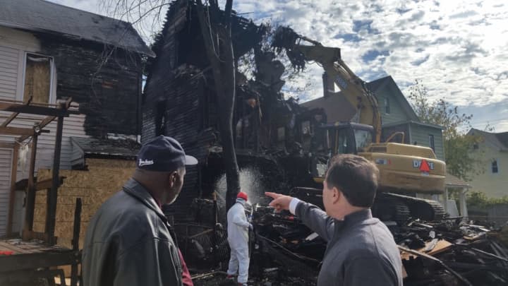 Bridgeport Fire Deputy Chief Lance Edwards, left, and Mayor Joe Ganim survey a blighted building being torn down on Newfield Avenue.