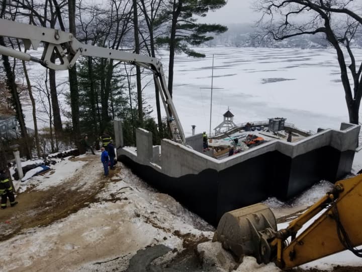 A construction worker injured at a home construction site on Forty Acre Mountain Road in Danbury on Thursday was pulled to safety by firefighters and tree workers.