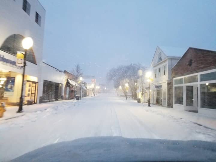 Westport&#x27;s snowy Main Street looking quiet and serene Wednesday evening before trees started falling and power went out.