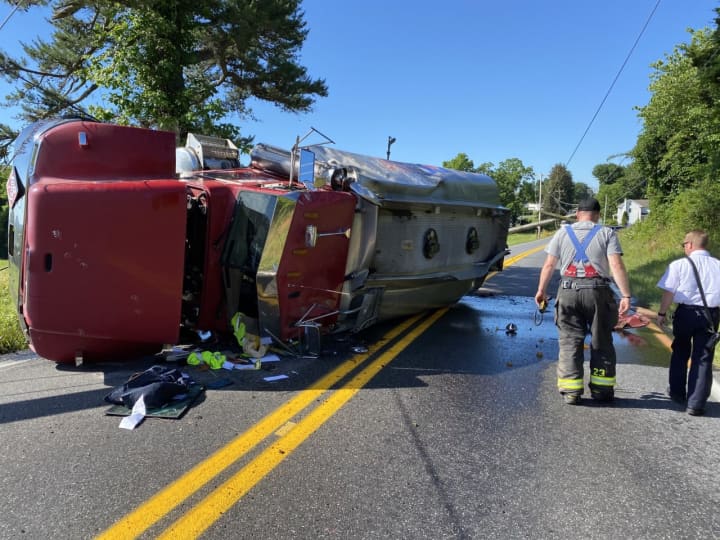 The truck rolled over, spilling oil onto Route 74.