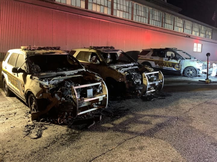 The burned police cruisers.